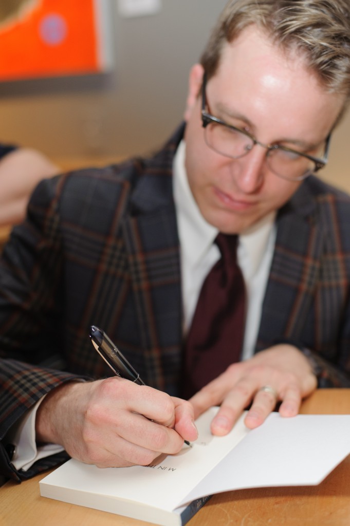 Douglas signing a book